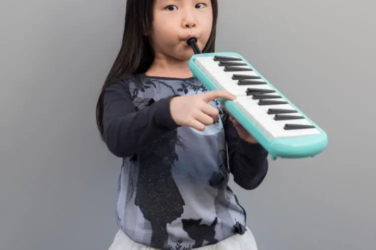 Girl playing melodica